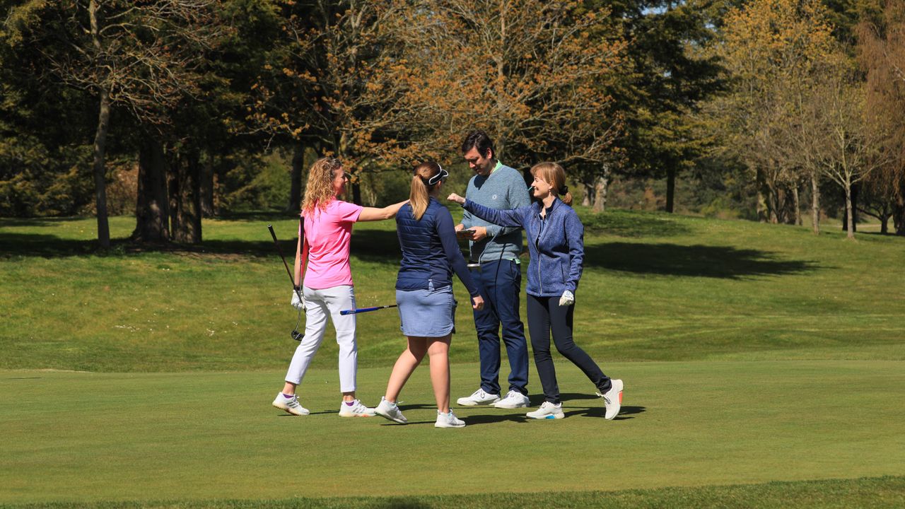 Golfers celebrating on green