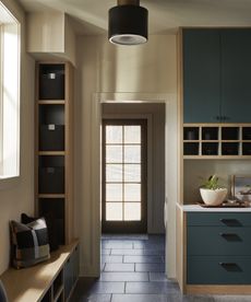 mudroom with blue cabinets and dark floor