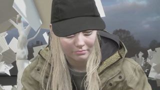 A leaked image from Resident Evil 8 depicting the face of a blonde woman. The background is composed of unfinished, untextured game polygons.