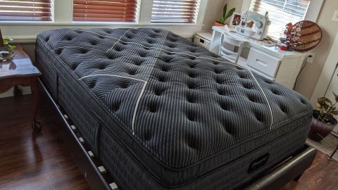 The Beautyrest Black K-Class Plush Pillow Top mattress on a bed in a bedroom
