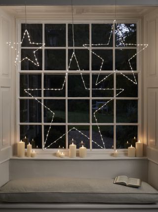 Christmas window decor with star curtain light and candles