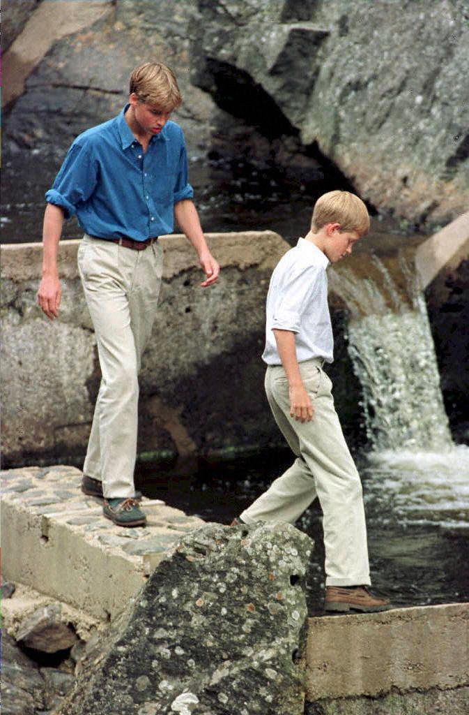 Prince William and Prince Harry walking by a waterfall at Balmoral
