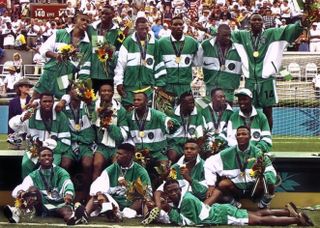 Nigeria players pose with their gold medals after winning the men's football tournament at the 1996 Olympics.