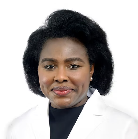 a black woman with a brown bob wearing a white lab coat