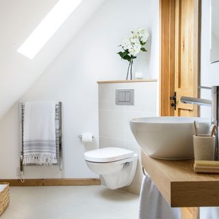 white ceramic sink beside bathtub