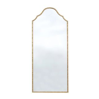 A gold arched floor length mirror