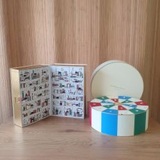 The Diptyque and Jo Malone advent calendars on a wooden table with a panelled backdrop