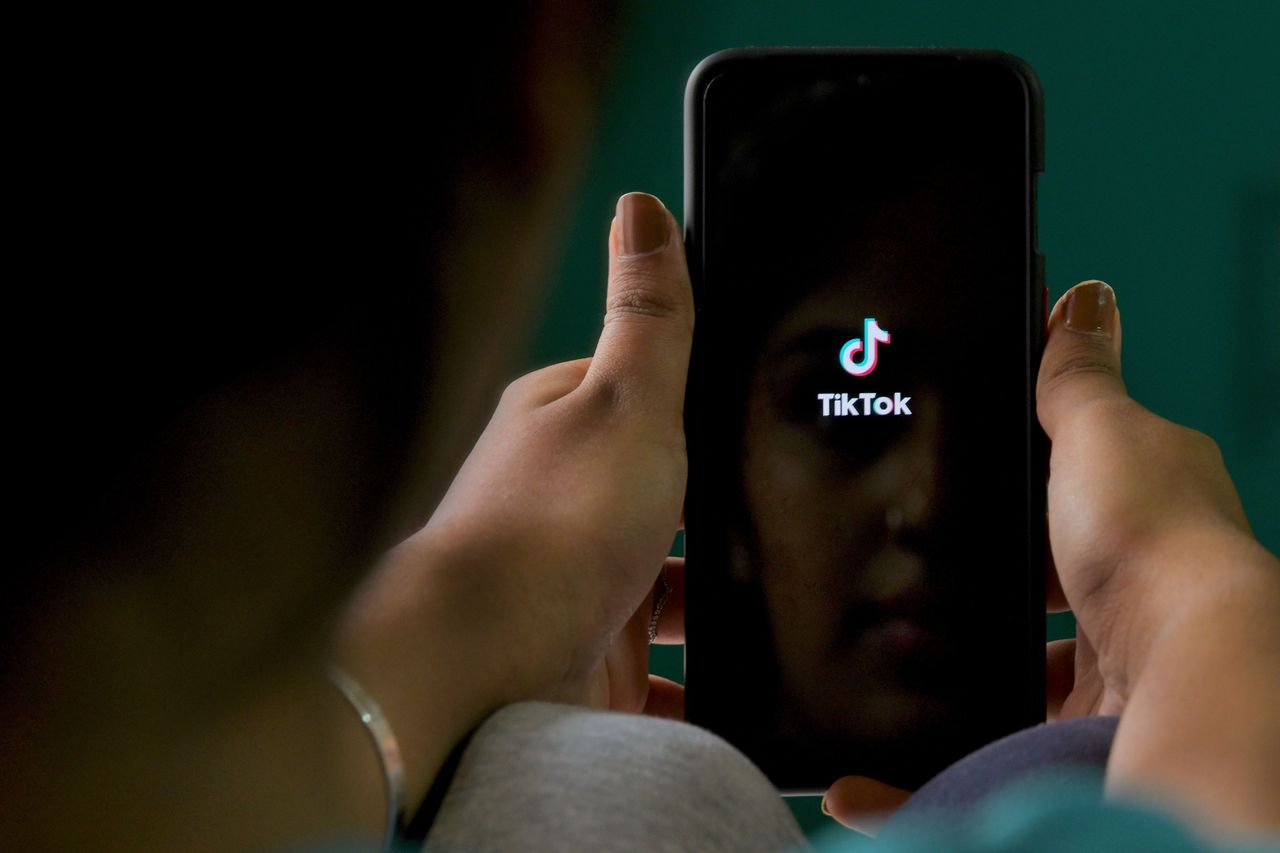 The TikTok logo on a phone