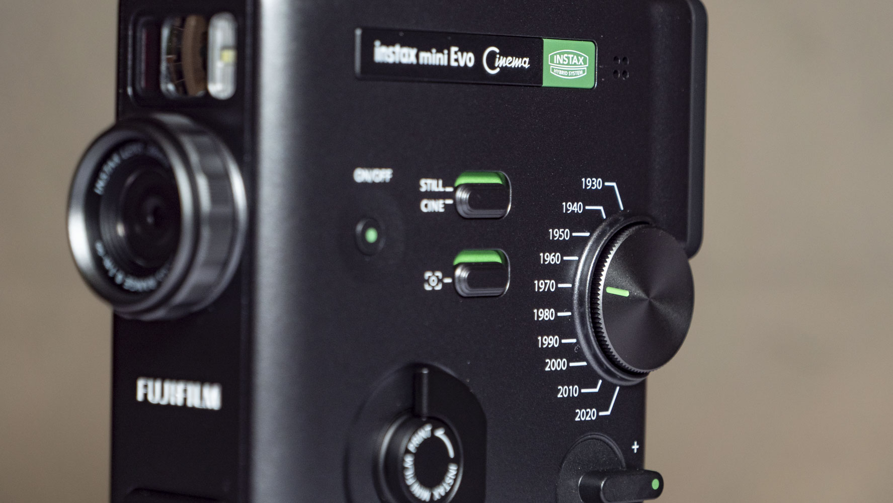 Fujifilm Instax Mini Evo Cinema on a white wooden surface