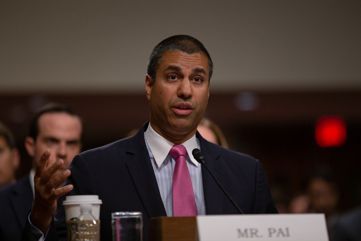 Ajit Pai sitting at a desk