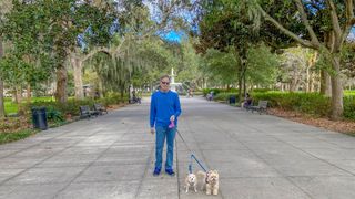 Man with two dogs in park in Savannah