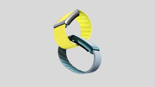 Two Whoop 4.0 fitness trackers interlocked in front of a grey background