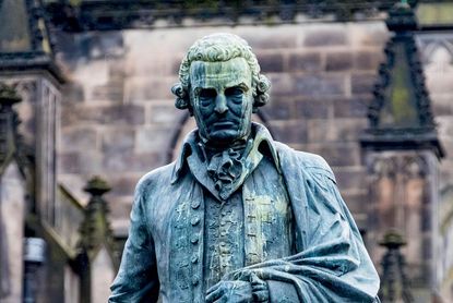 Government debt crisis: statue of economist Adam Smith
