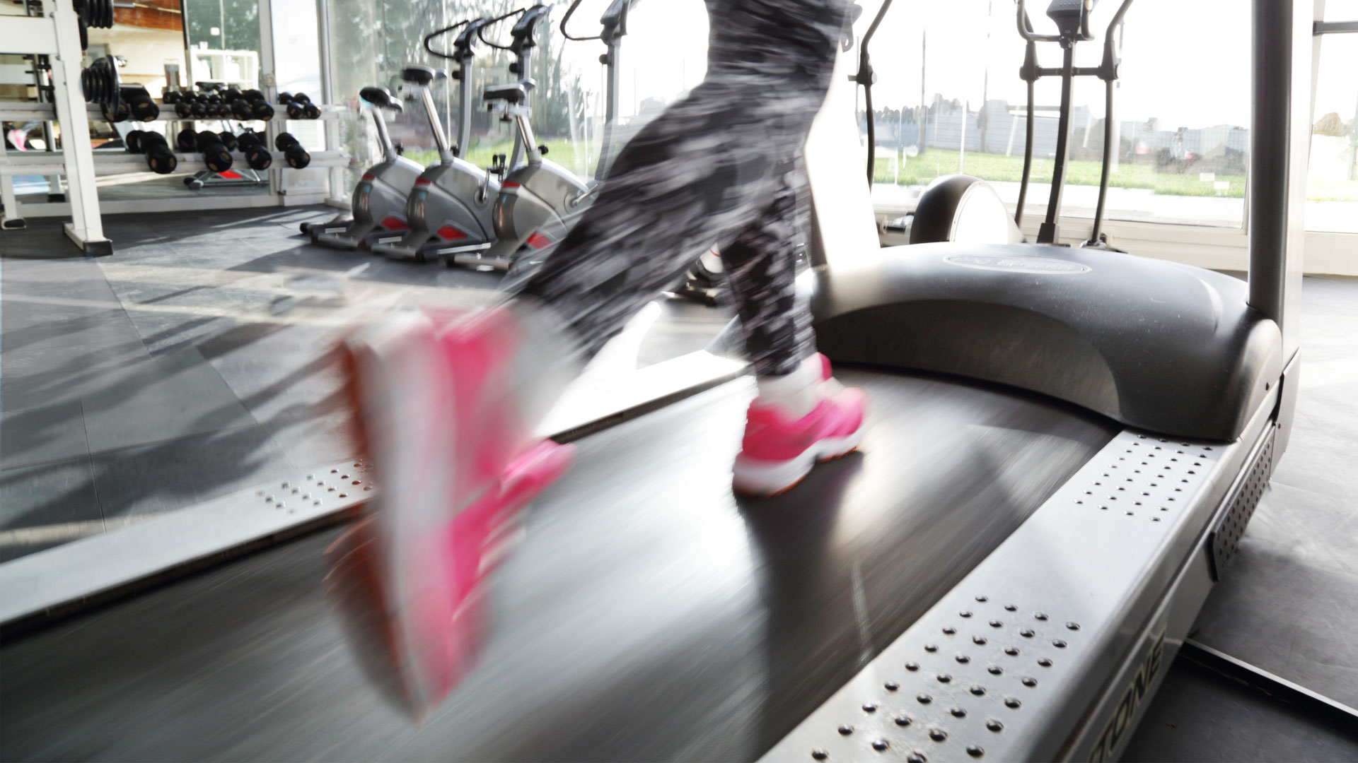 Rowing Machines vs Treadmills: Which is best for home use? image of runner's feet on treadmill