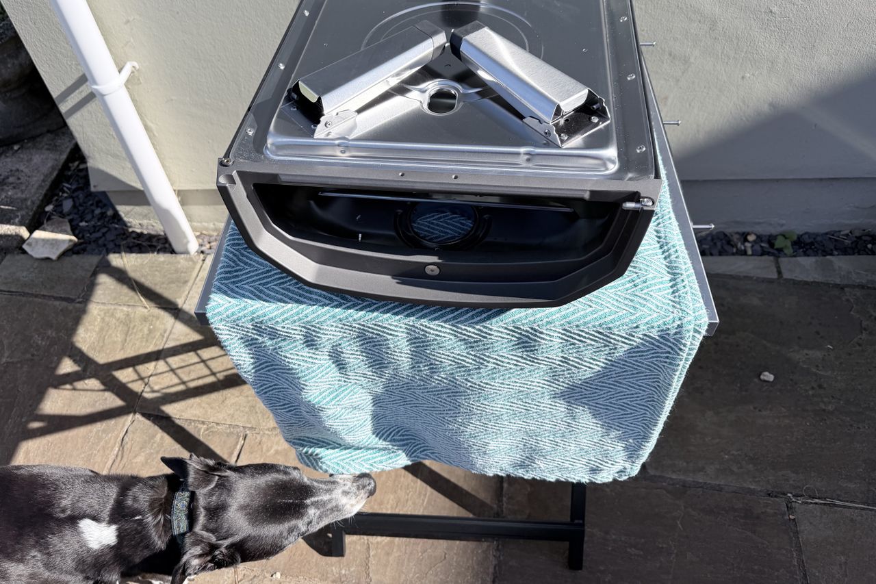 The Ooni Karu 2 being built, with a dog sniffing the pizza oven