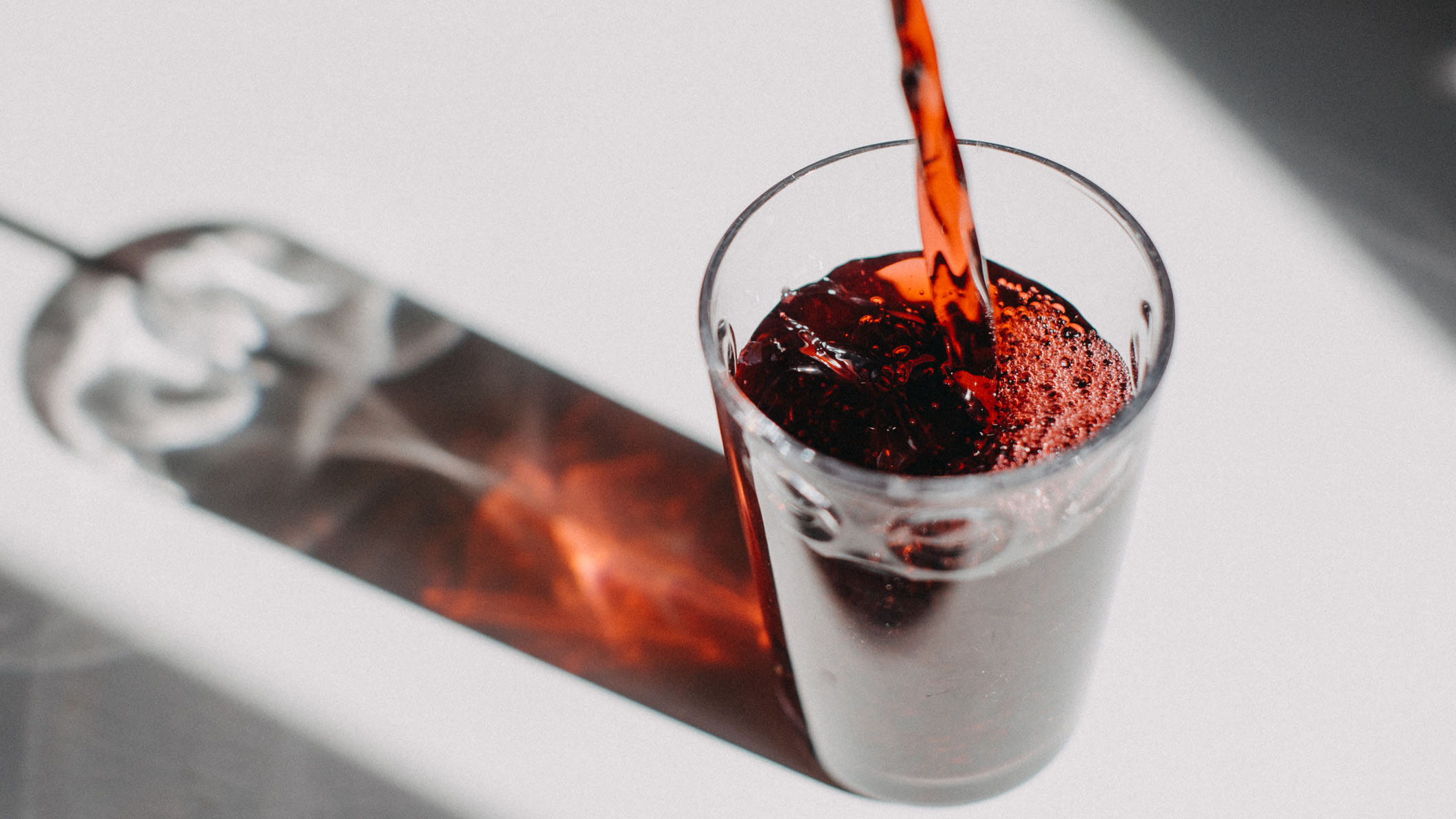 Tart cherry juice poured into a transparent glass