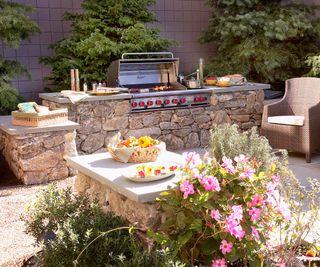 Stone outdoor kitchen with a built-in grill