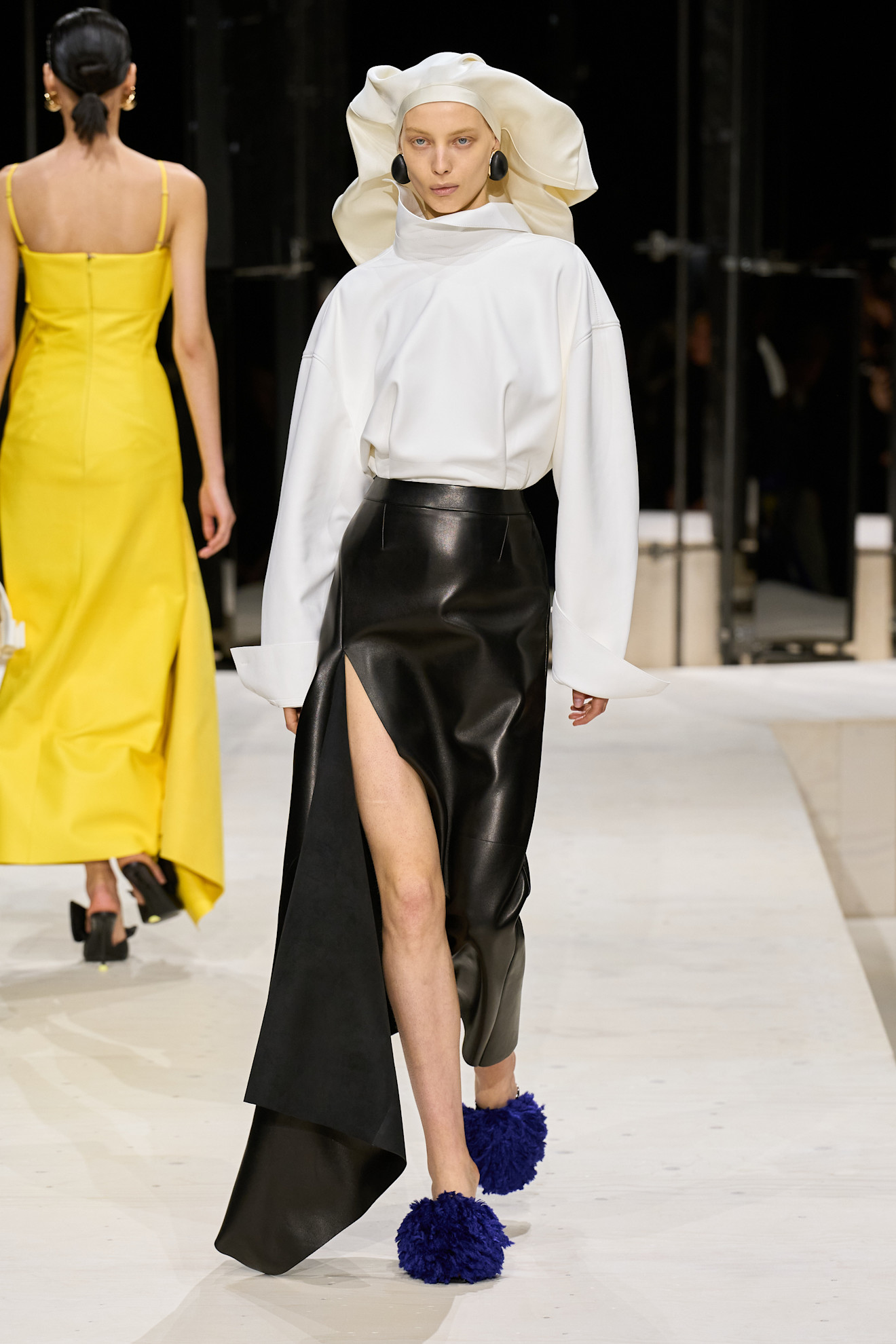 a model wears a headcovering on the givenchy f/w 26 runway.