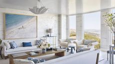 living room with white sofas and walls ocean view