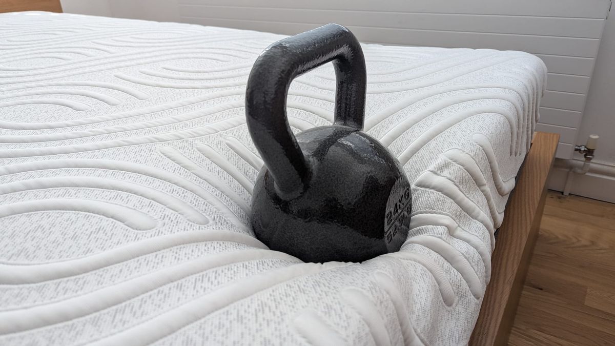 A 56lb kettlebell placed at the foot of the mattress to asses its edge support