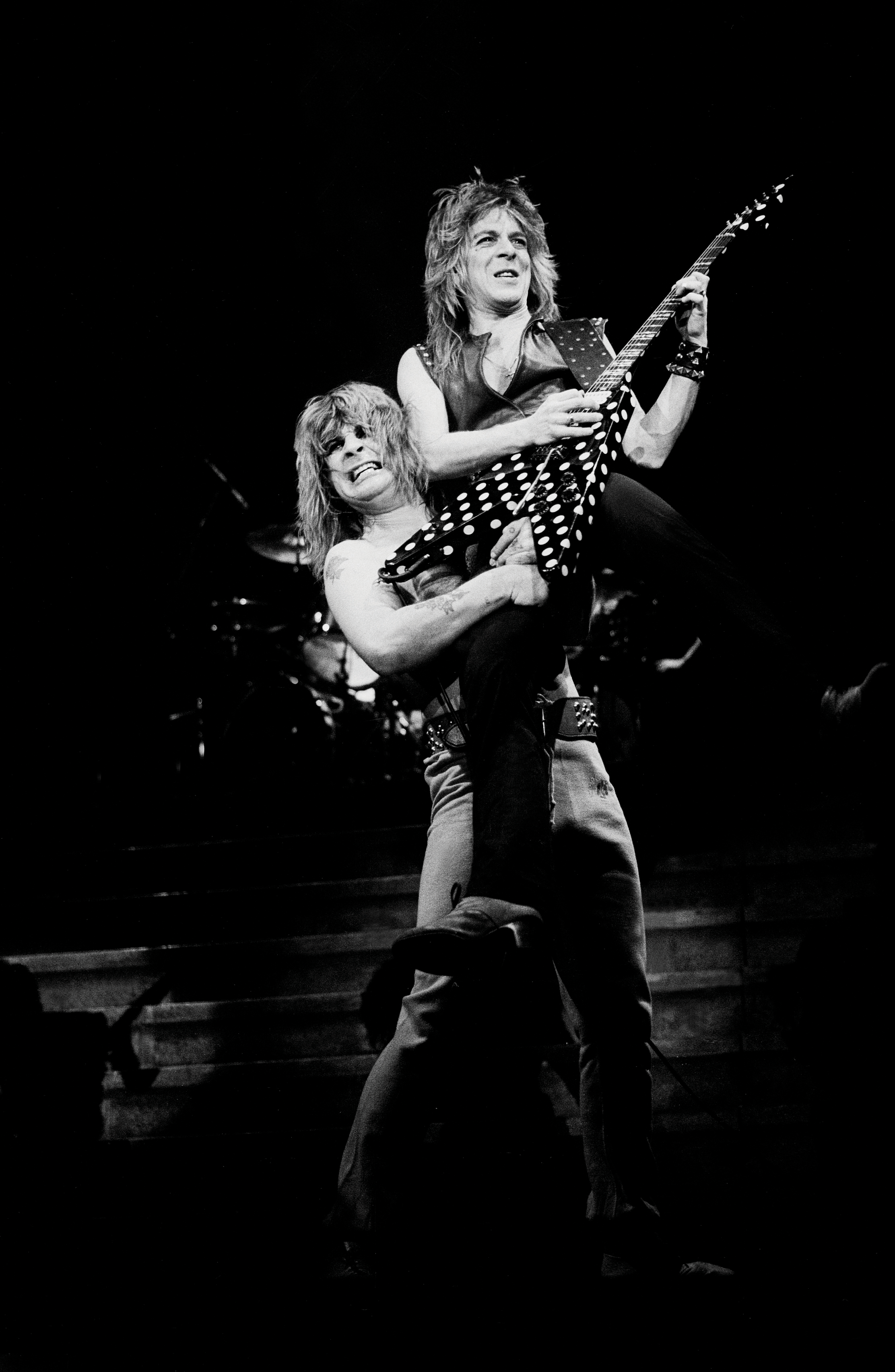 Ozzy Osbourne holding Randy Rhoads up on stage