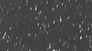 a white dot visible among blurry star streaks