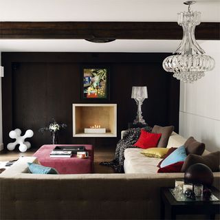 Living room with black wall wooden flooring and sofa set with cushion