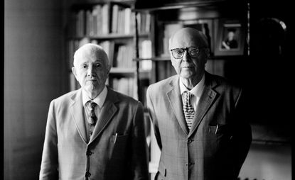 Artists Gilbert & George in suits photographed side by side