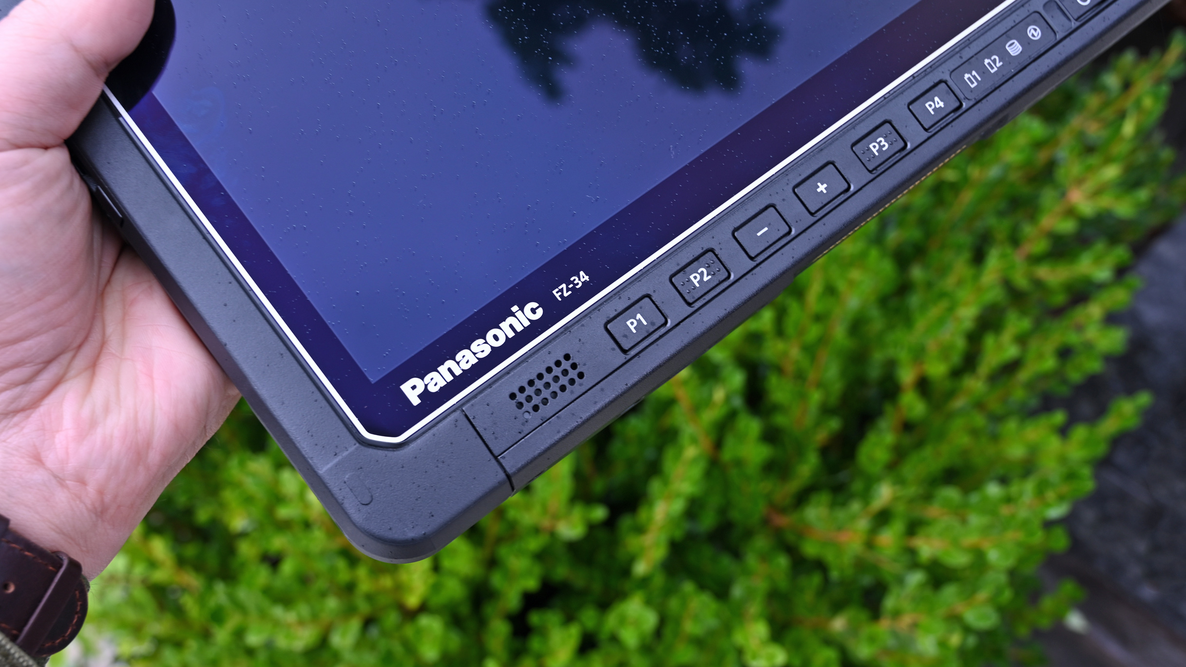 Close-up of the lower bezel on a Panasonic TOUGHBOOK FZ-34 tablet, featuring hardware function buttons (P1-P4) and speaker.