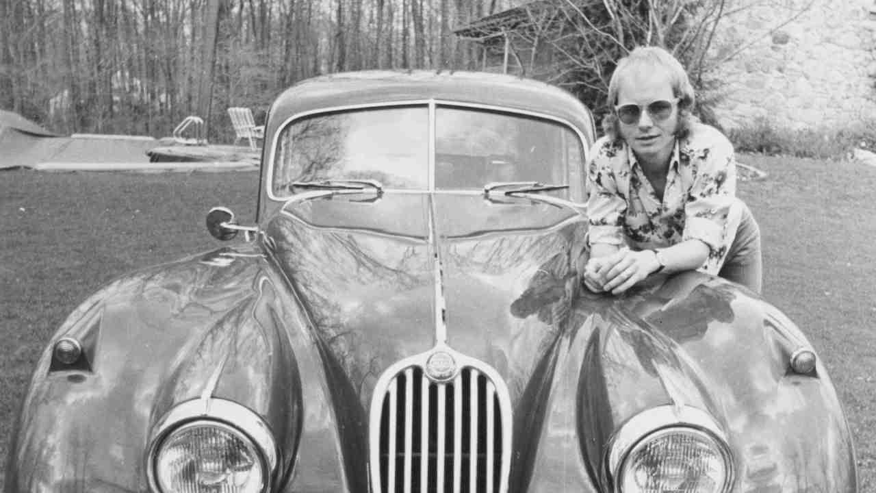 Wishbone Ash posing for a photograph with a car in the 1970s