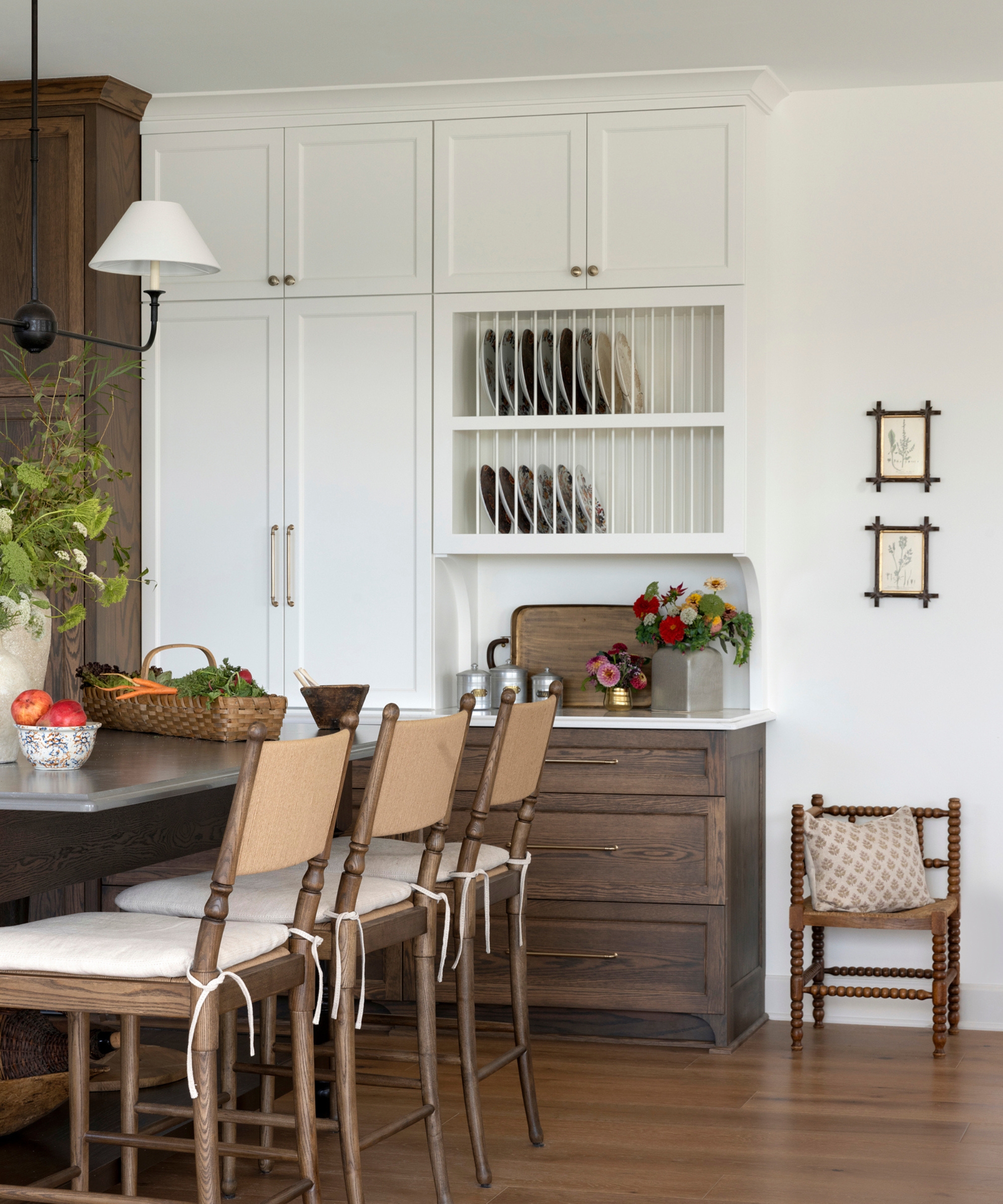 A wood and white kitchen with plate racks integrated into the cabinetry