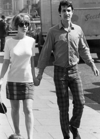 1966: Mayfair and Bond Street are giving way to Soho's Carnaby Street and the King's Road, Chelsea - a young couple, wearing the fashions of 'Swinging London'.