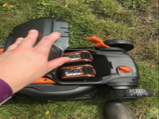 fitting the batteries in the Worx 40V cordless lawn mower