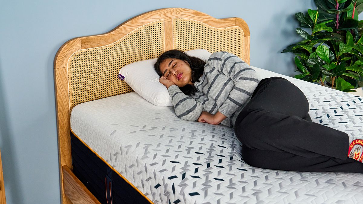 A female Tom's Guide mattress tester sleeping comfortably on her side on the Nectar Ultra Hybrid mattress