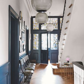 hallway with grey doors and wooden flooring