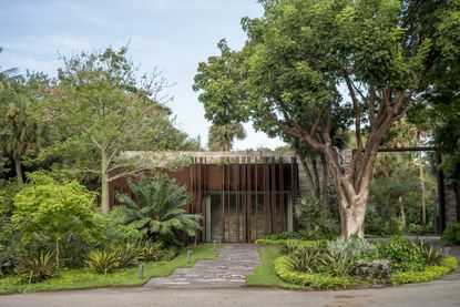 The Coconut Grove Gatehouse by Rene Gonzalez structure seen among foliage