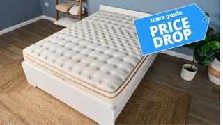 A picture of the Saatva Classic mattress on a white bedroom in a modern bedroom. 