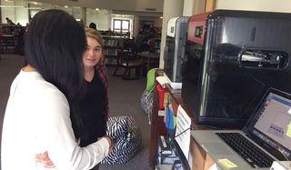 Students discussing 3D printing in the Yorktown High School Library