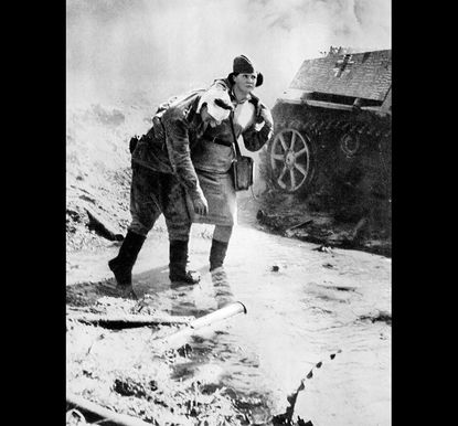 A Soviet nurse helps a wounded soldier at the front.
