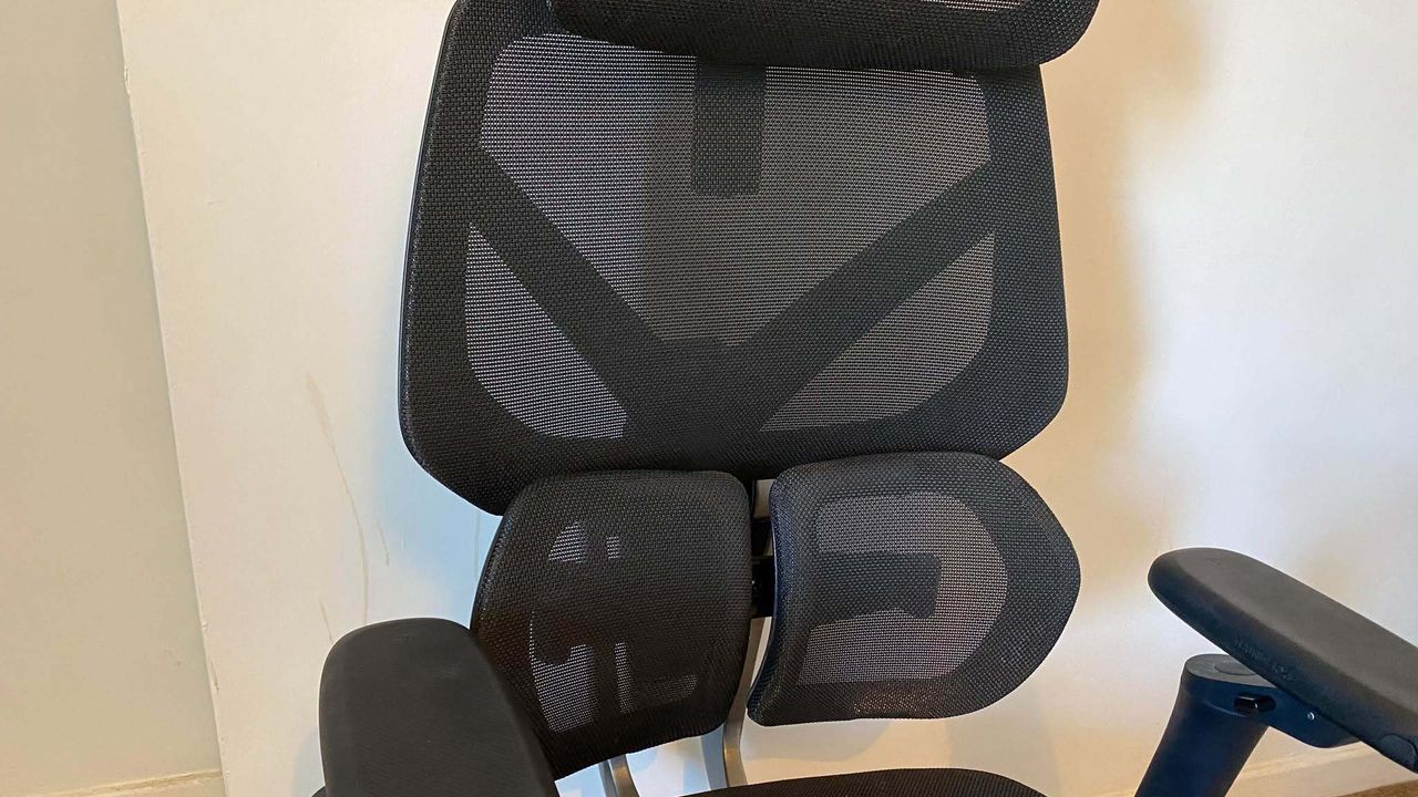 ThunderX3 chair set up in front of a white wall.