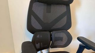 ThunderX3 chair set up in front of a white wall.