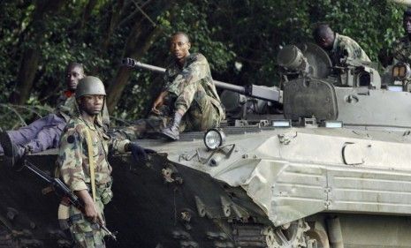 Forces loyal to Ivory Coast&amp;#039;s president-elect Alassane Ouattara rest on Saturday, before battling forces aligned with former president Laurent Gbagbo.