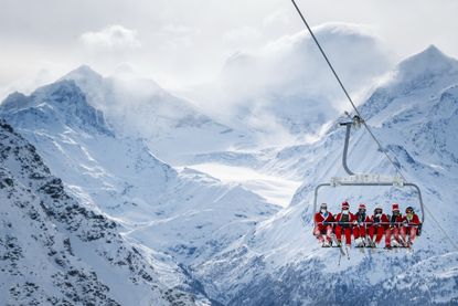 Santas go for a ski.