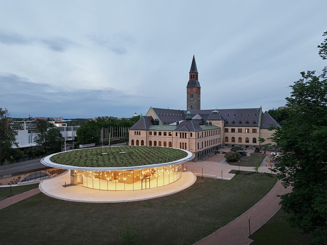 JKMM - National Museum of Finland view of round, white and gold underground building next to the historical one