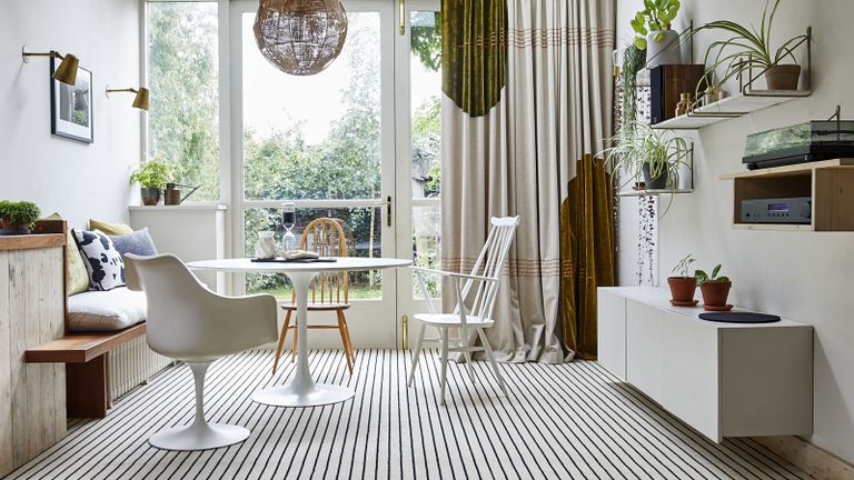 A ground floor casual dining area with a white carpet with pinstripe decor