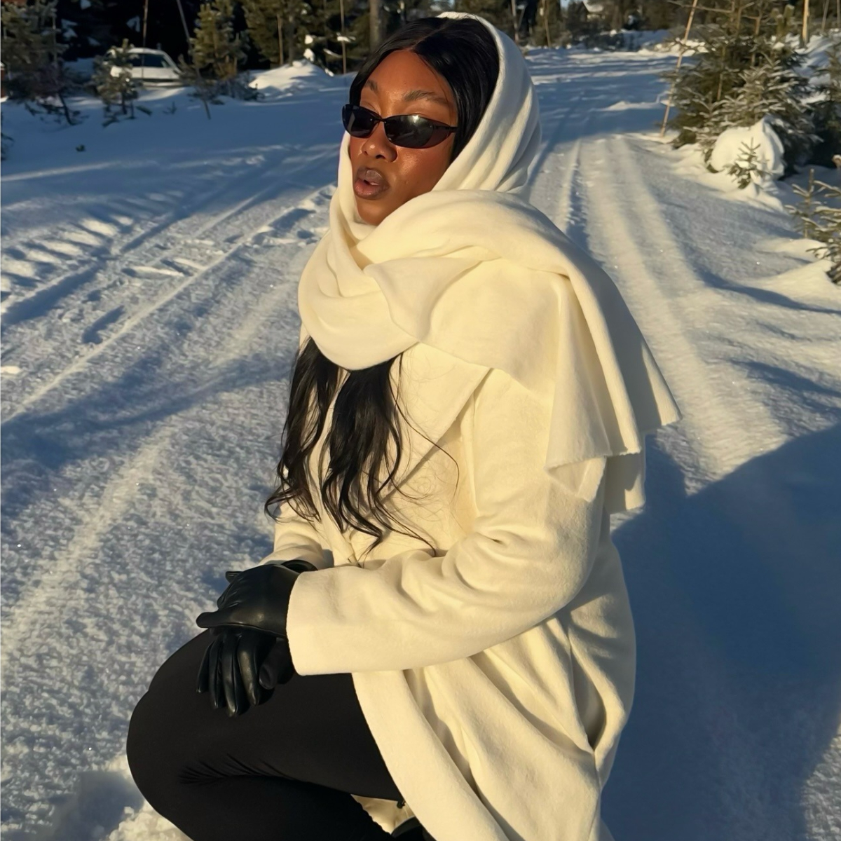 A woman sits outside in the snow