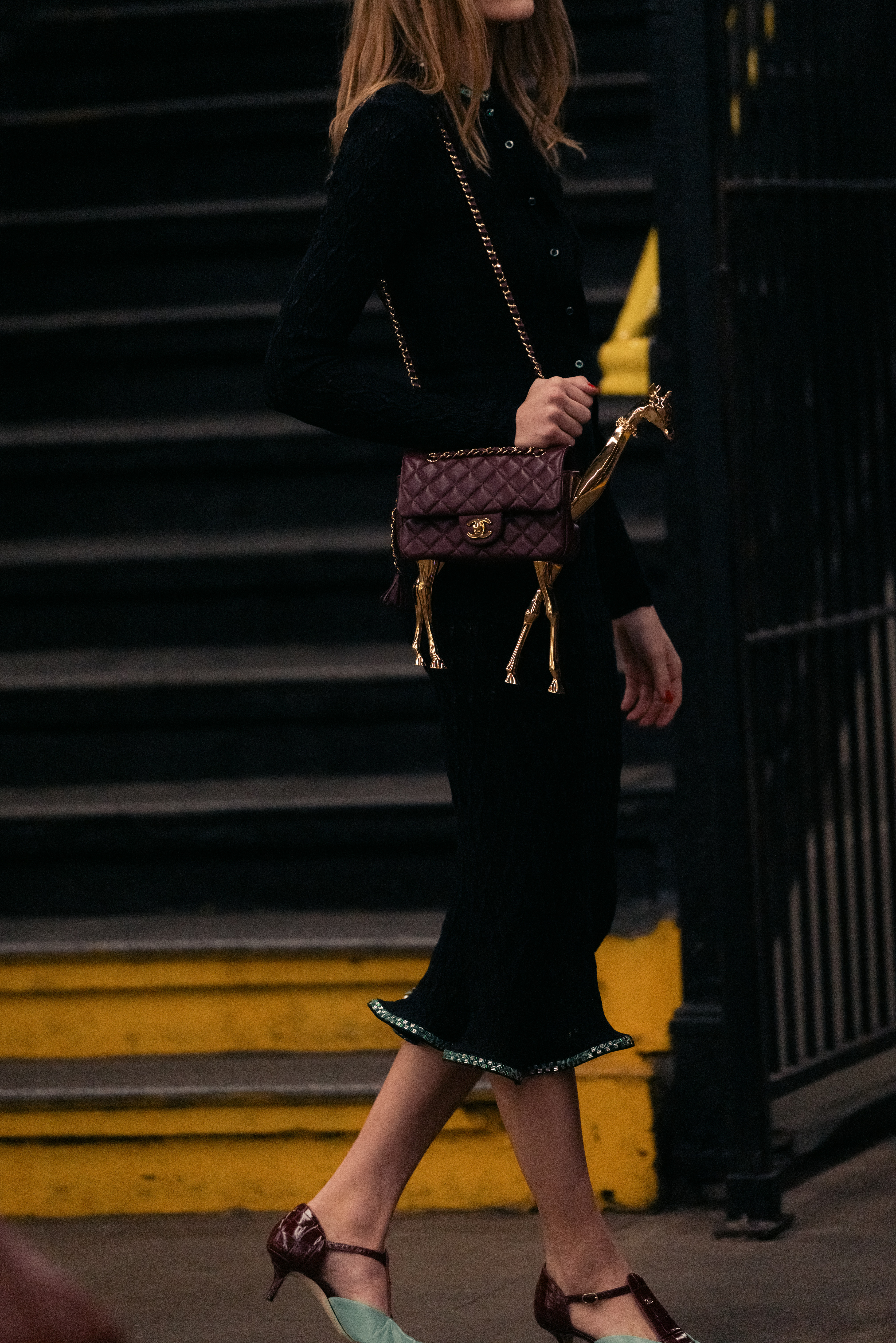 a model carrying a giraffe bag during the chanel metiers d'art 2026 show