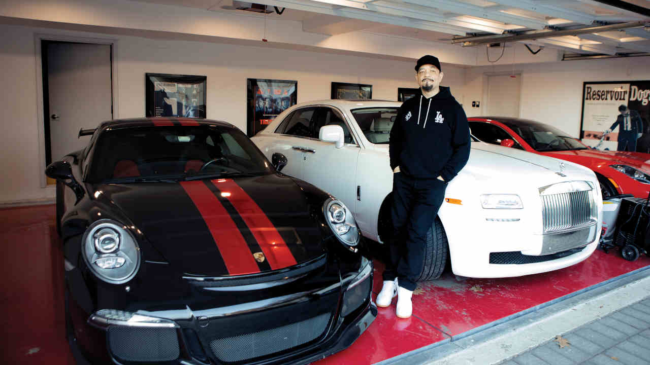 Ice T posing for a photograph at home with his cars