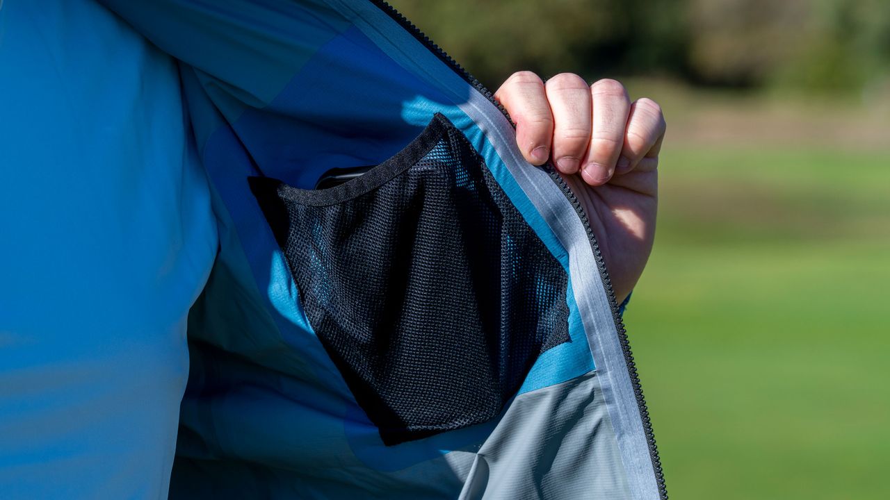 A view of a golfer showcasing the inside pocket of the FJ Arcus jacket