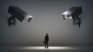 A CGI render of a model businessperson placed on a white floor, with two large CCTV cameras watching them to represent AI employee monitoring and employer tracking. The scene is darkly lit, with the model businessperson lit with a spotlight to emphasize them being monitored.